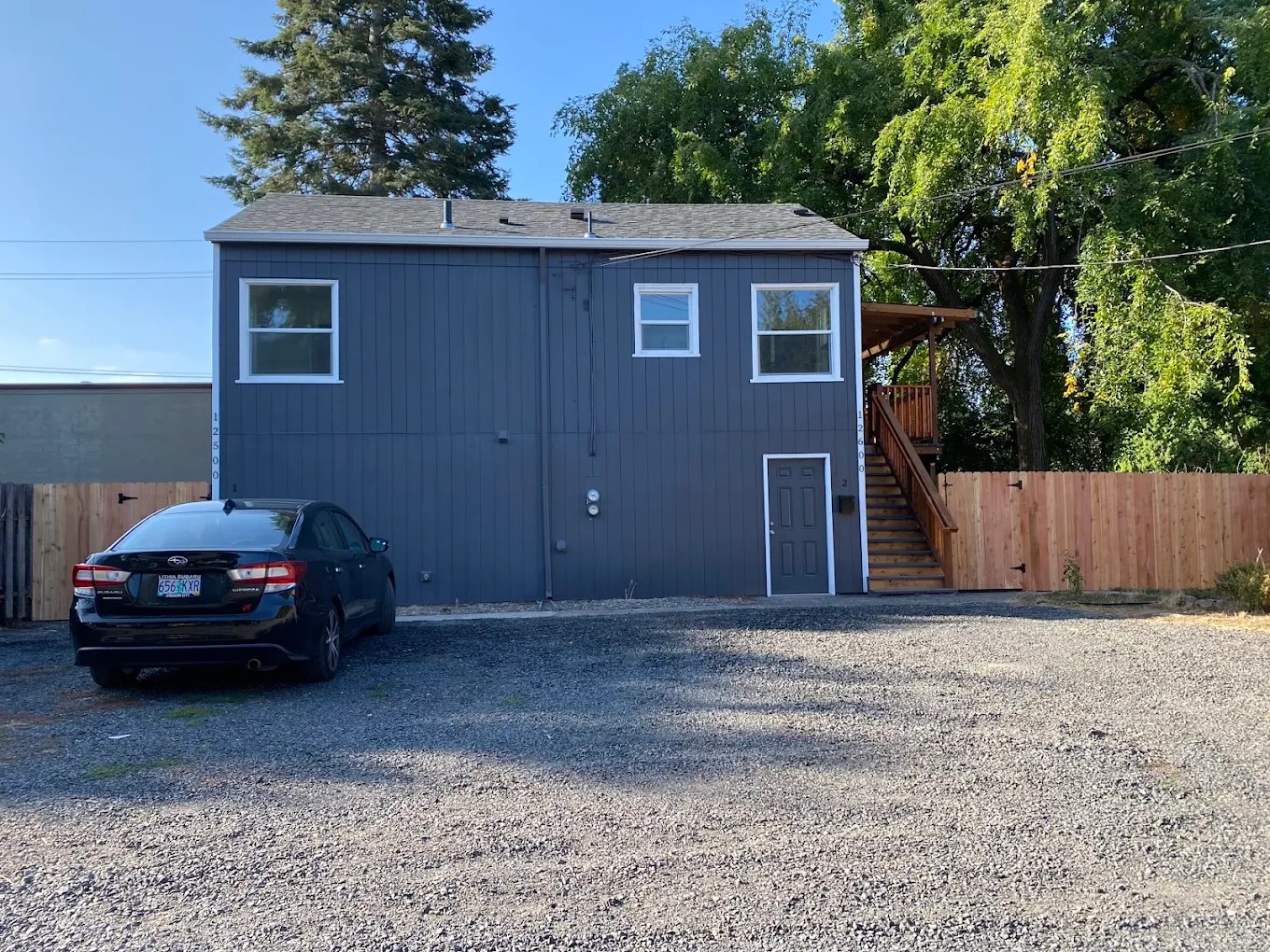 Firefly Family Collective building and parking, gravel road entrance